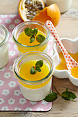 Coconut panna cotta with passion fruit sauce in jars