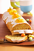 Carrot cake with icing and sugar eggs for Easter