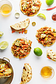 Mexican tacos with chili con carne, grilled sweet potatoes and grated cheese on white background