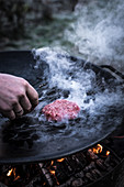 A hamburger patty being grilled