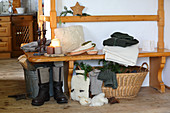 Knit fabrics and rustic wintry accessories on stove bench in cabin parlour