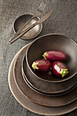 Miniature aubergines in bowl