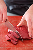Trimmed and soaked beef heart being sliced