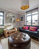 Large brown leather ottoman in living room in earthy shades