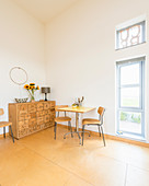 Simple dining area and chest of drawers with carved letters on front