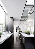 Black and white designer kitchen with island in an open living room