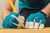 Carpenter measuring wood