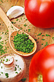 Chopped parsley on wooden spoon