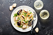 Spaghetti vongole (pasta with mussels, Italy) served with white wine