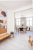 Open doorway leading into dining room with Scandinavian designer chairs