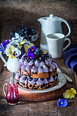 Festive berry cake with edible flowers