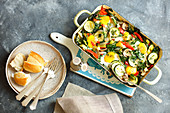Eggs with oven-baked vegetables in a baking dish