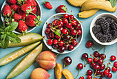 Healthy summer fruit variety - Cherries, strawberries, blackberries, peaches, bananas, melon slices and mint leaves
