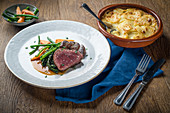 Roast beef with vegetables and potato gratin