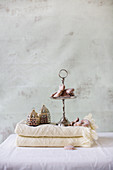 Gingerbread hearts on cakes stand and Oriental lanterns on folded blanket