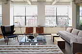 Elegante Lounge mit hellen Polstermöbeln und Designerstühlen
