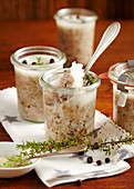 Homemade pork rillette in jars with a silver spoon