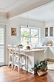 Two barstools at white kitchen counter