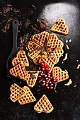Waffles with grated chocolate and pomegranate seeds (seen from above)