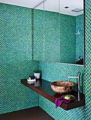 Mirror cabinet and vanity in the bathroom with mosaic tiles in green tones