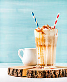 Latte macchiato with whipped cream and caramel sauce