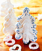 Meringue Christmas tress decorated with sugar sprinkles
