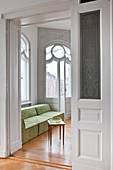 Pastel-green couch seen through open interior door