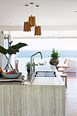 Kitchen island with stone top; View of the terrace and the sea