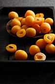 Sweet summer yellow plums on wooden tray