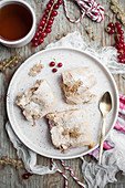 White and red currant cake with meringue toppingwith cup of tea