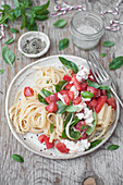 Pasta caprese - pasta with fresh tomatoes, basil, mozzarella and olive oil