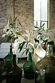 White lilies in white and green demijohns