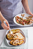 Crostini mare e terra (grilled bread with grilled red mullet and porcini mushrooms, Italy) being made