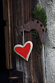 Heart pendant hung on wooden door
