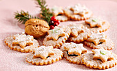 Jam biscuits with icing sugar and silver pearls