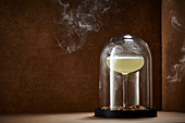 Smoked mezcal sour under a glass cloche
