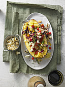 Warm spaghetti squash salad with fried leek, cherry tomatoes, capers and chilli popcorn