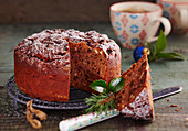 A small chocolate honey cake with almonds and raisins for Christmas