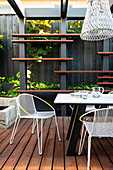 Modern garden furniture on the covered terrace with wooden deck