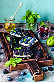Sandwiches with berries and honey and blackberry non-alcoholic mojito