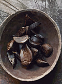 Black garlic in a wooden bowl