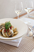 White Bowl Appetizer of Clams with Pieces of Sausage