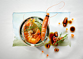 Food art: prawns with caviar, soy sauce and dill on a page of watercolour