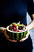 Watermelon fruit bowl held in a womans hands