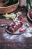 Slice old cherry chocolate cake on a dessert plate