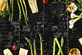 Grilled vegetables green asparagus, garlic, lemon, spring onion, zucchini, cherry tomatoes, salad on bbq grill rack over charcoal