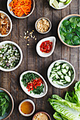 Lettuce cup ingredients in bowls on wood background