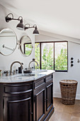 Twin sinks in washstand with marble top in bathroom