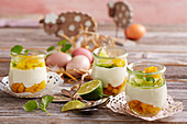 Yogurt cream with lime and mango in glasses for Easter