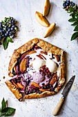 Peach and Blueberry Galette on a marble background